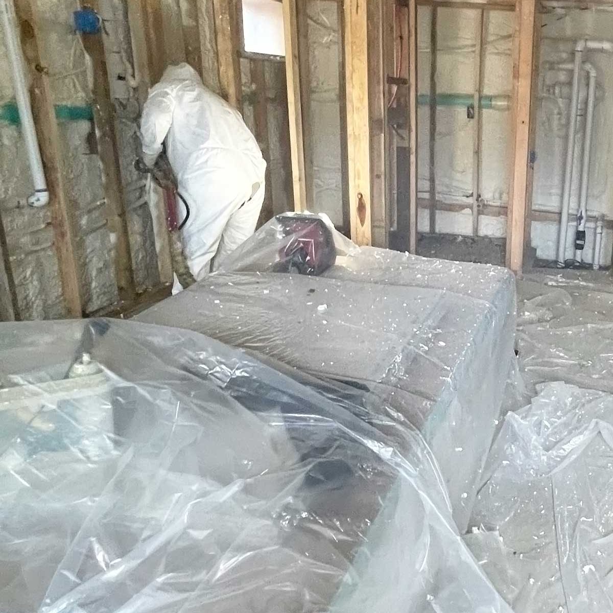spray foam insulation technician at work Long Island