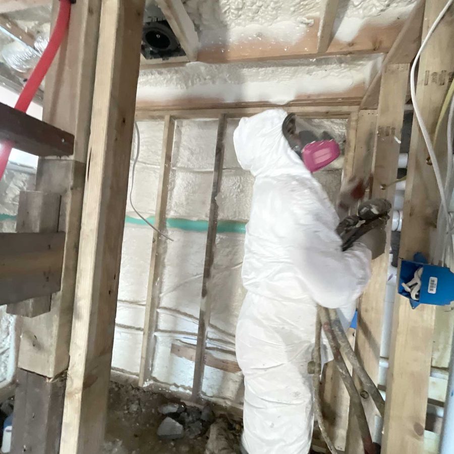 Technician spraying closed cell foam insulation